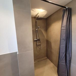 a bathroom with a shower with a shower curtain at VineSinn in Maikammer +110 photos
