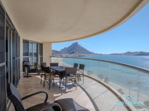 a balcony with a table and chairs and the view of the ocean at Playa Blanca Premier Unit 810 in San Carlos