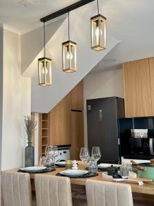 a kitchen with a dining table with chairs and lights at Casa Roriz in Favaios +44 photos
