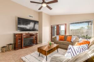 a living room with a couch and a flat screen tv at 136th Surprise in Surprise