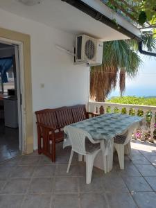 a table and chairs on a patio with a view of the ocean at Apartments Nikvik in Budva