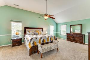 Un dormitorio con una cama y un ventilador de techo. en Spacious Family Home with Patio in Graniteville!, en Graniteville