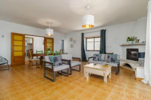 a living room filled with furniture and a fireplace at Ericeira - Casa Tia Alice in Ericeira