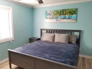 a bedroom with a bed with a blue wall at 206 on 10th St - All in Saint Augustine