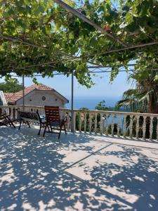 a bench on a balcony with a view of the ocean at Apartments Nikvik in Budva