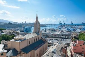 a view of a city with a church and a harbor at Genova Host - Una Finestra sul Mare in Genova