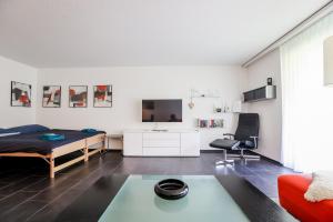 a living room with a couch and a table at Rothornblick 8 in Arosa