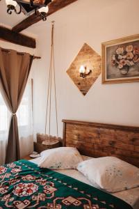 a bedroom with a bed and a picture on the wall at Casa pe Valea Hartibaciului(Bărcuț) in Bărcuţ