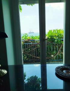 a view of the ocean from a room with a window at Hotel Palladio in Giardini Naxos