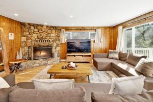a living room with a couch and a fireplace at Conklin paradise #1993 in Big Bear Lake