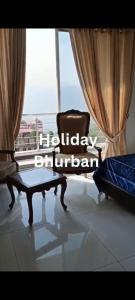 a room with a chair and a large window at Holiday Rest Inn in Bhurban