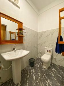 a bathroom with a sink and a toilet at Oasis Garden - Arugam Bay in Arugam Bay