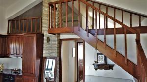 a wooden staircase in a living room at Dionysus Blue Sky in Egina