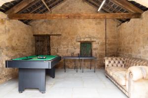 a room with a pool table and a couch at Mill Cottage in Newlands