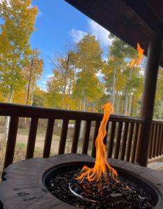 Una fogata en una mesa en un porche en 6 Bedroom Cabin by Xquisite Rentals, en Heber City
