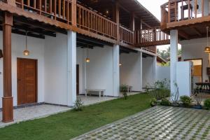 a courtyard of a house with a wooden door at Oasis Garden - Arugam Bay in Arugam Bay +56 photos