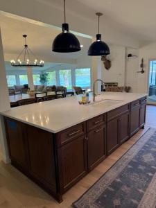 a kitchen with a large island with a sink at Remodeled Lake Retreat Putting Green, Game RoomBar in Green Lake