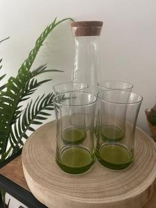 three glasses on a wooden tray with a vase at Buda Side Comfort in Budapest