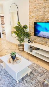 a living room with a tv and a white coffee table at BKM Lake View Retreat at Leisure Bay Estate in Pretoria +35 photos