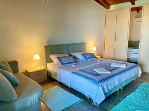 a bedroom with a large bed and a couch at Ribarica GO green in Ribarica