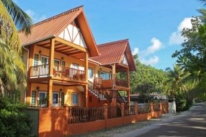 a building with balconies on the side of a street at Green Blue Beach House in Baie Lazare Mahé