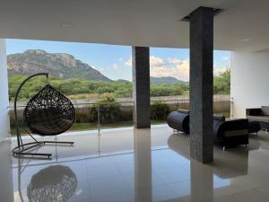 a living room with a view of a mountain at Felipe Hotel in Serra Talhada
