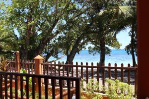 a fence on the beach with the ocean in the background at Green Blue Beach House in Baie Lazare Mahé