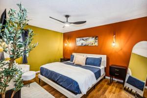 a bedroom with a bed and a yellow wall at Theater, King&PoolTable with PrivateHotTub in The Dell