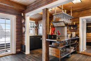 a kitchen with wooden walls and wooden floors at Trysilfjell 636 by Vacation Trysil in Trysil