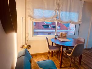 a room with a table and chairs and a window at LEB Apartments in Pineda de Mar