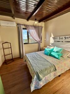 a bedroom with a large bed with a window at LA BRUJA BUENA Casa Boutique in Loreto