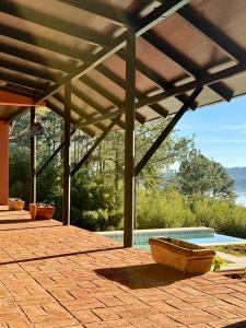 a pavilion with a wooden boat sitting on a patio at LA BRUJA BUENA Casa Boutique in Loreto