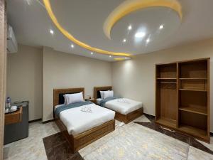 a bedroom with two beds and a circular ceiling at The Pyramids Crypt Inn in Cairo