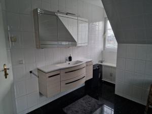 a white bathroom with a sink and a mirror at Nahe Berlin 224qm Traumhaus im Grünen mit Sauna und Kamin in Berlin +20 photos