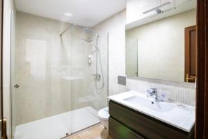 a bathroom with a glass shower and a sink at Hotel Boutique Zahara in Zahara de los Atunes