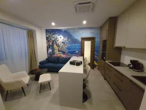 a kitchen with a living room with a couch at Sole di Mare in Opatija