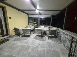 a patio with a table and chairs on a patio at Sole di Mare in Opatija +6 photos