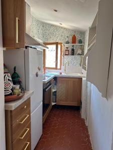 Una pequeña cocina con nevera y fregadero. en Charming flat in St Paul village, en Saint-Paul-de-Vence 1 foto más
