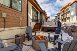a patio with chairs and a fire pit with a piano at Klaim Retreats 807 in Park City
