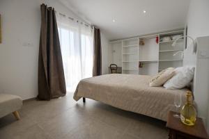 a bedroom with a bed and a large window at Paj - Villa for 10 Terrace with Pool - by TGB in Porticcio