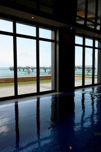 an empty room with windows and a view of the ocean at Apartament 330 Przy Plaży, parking gratis! in Międzyzdroje