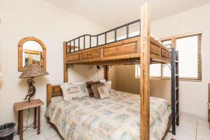 a bedroom with a bunk bed and a lamp at Wait 'n Sea Retreat Spacious Oceanfront Condo in Puerto Peñasco +30 photos