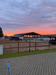 a pavilion with benches and a light pole on a beach at Hengstresort Velten in Velten