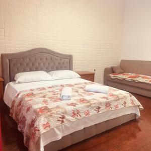 a bedroom with a bed with a quilt on it at Venice Cappucina Guest House in Venice