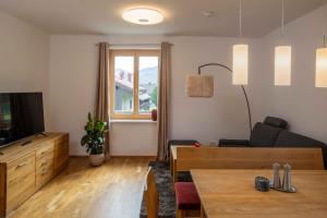 a living room with a couch and a table at Triebenstein Hideaway in Hohentauern