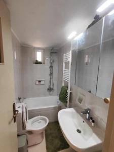 a bathroom with a sink and a toilet and a tub at loupagio di mare in Plátanos +34 photos