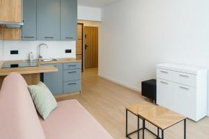 a kitchen with a couch and a table in a room at Mieszkanko centerum in Tarnobrzeg