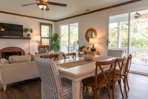 a living room with a table and chairs and a couch at 18 Veranda Beach Drive in Fripp Island