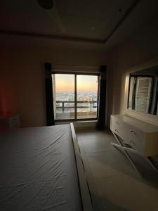 a bedroom with a large window with a view at 2-BHK Stay Minutes from the Airport & Motorway in Islamabad