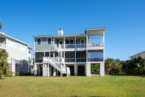 a large apartment building with a staircase in a yard at 449 Tarpon Blvd in Fripp Island